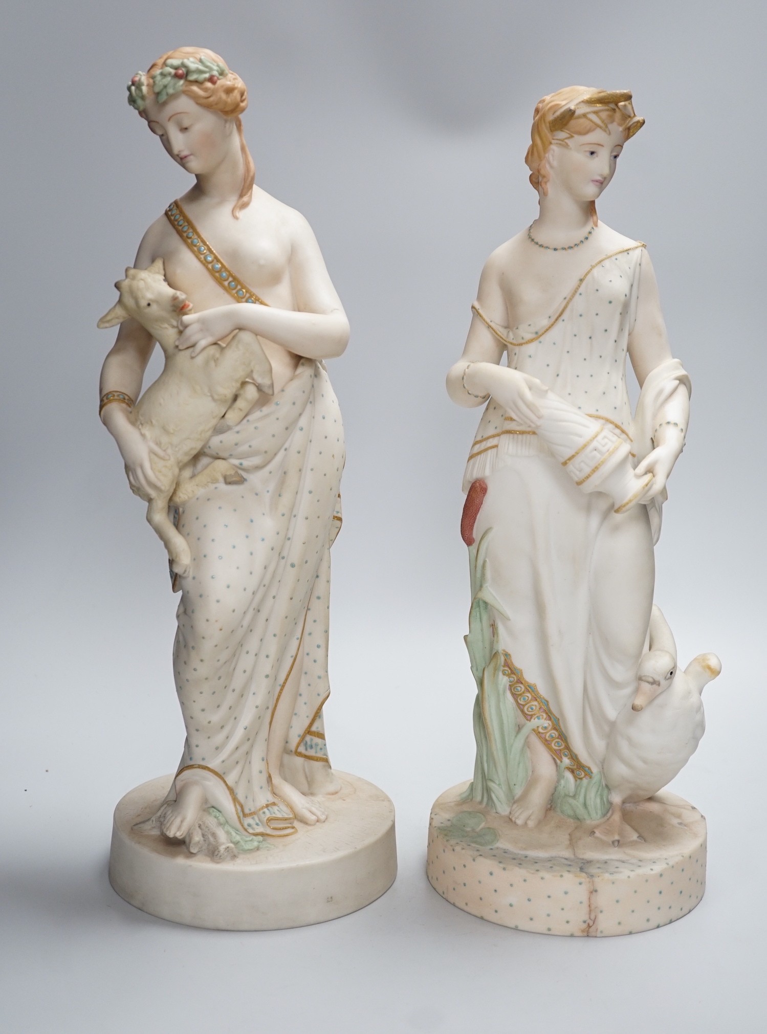 A pair of large W H Goss bisque classical female figures, one with lamb, the other Leda and the Swan, 45cm